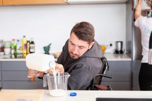 A NDIS participant has help in the kitchen from a tappON personal carer