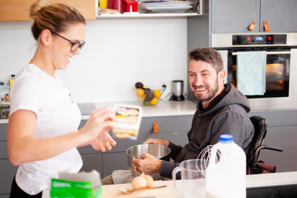 tappON support worker helping NDIS client in the kitchen