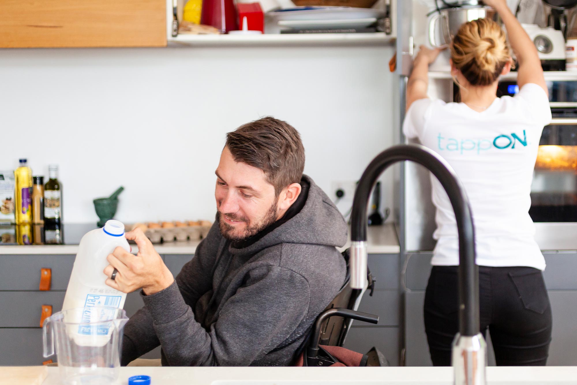 tappON NDIS Client and Carer working in the kitchen