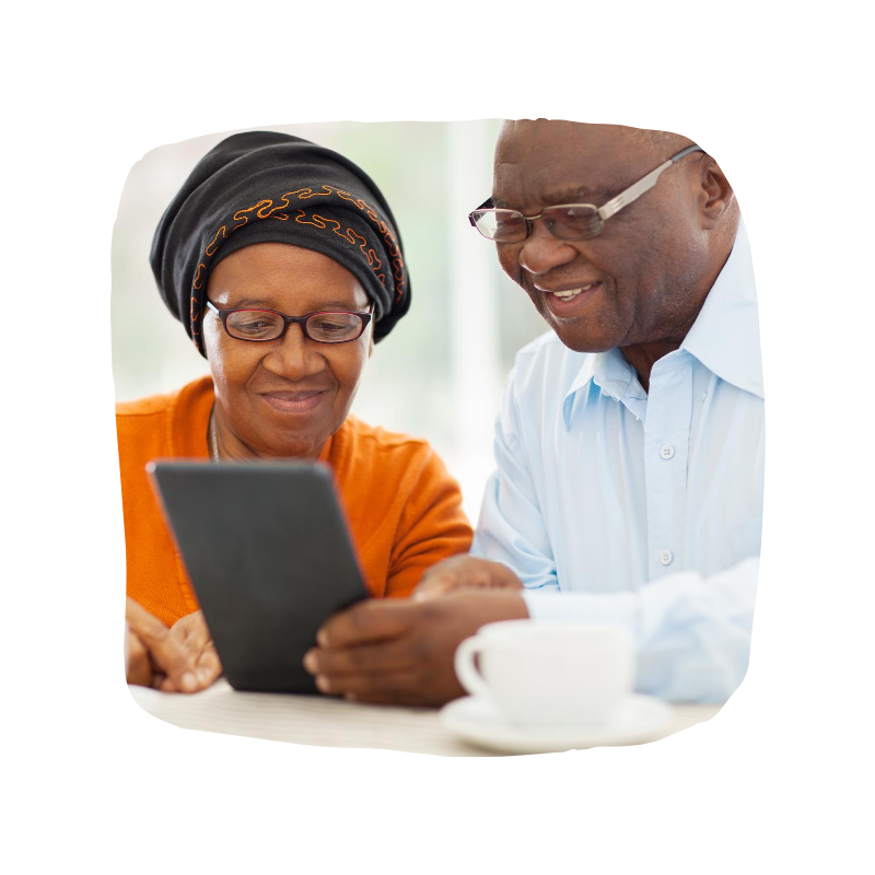 A woman and man sitting in front of a tablet device.